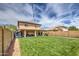 Expansive backyard featuring a lush lawn, covered patio, and fencing for privacy at 11301 W Glenrosa Ave, Phoenix, AZ 85037