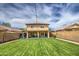 Large backyard features a well-kept lawn, patio, and block fence for privacy at 11301 W Glenrosa Ave, Phoenix, AZ 85037