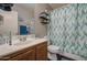 Bathroom featuring a sink, mirror, and toilet with a decorative shower curtain at 11301 W Glenrosa Ave, Phoenix, AZ 85037