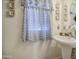 Bright bathroom showcases a stylish pedestal sink, decorative details, and a patterned curtain at 11301 W Glenrosa Ave, Phoenix, AZ 85037