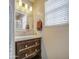 Bathroom vanity with a mirror and lighting fixture and a window with blinds at 11301 W Glenrosa Ave, Phoenix, AZ 85037