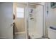 Tiled shower behind glass doors in bathroom with a window and neutral color scheme at 11301 W Glenrosa Ave, Phoenix, AZ 85037