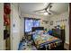 A bedroom featuring a patterned bedspread, ceiling fan, and ample decorations at 11301 W Glenrosa Ave, Phoenix, AZ 85037