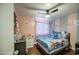 A bedroom with pink and grey walls, a bed, and various decorations at 11301 W Glenrosa Ave, Phoenix, AZ 85037