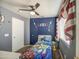 Bedroom featuring a bed with patterned bedding, blue walls, and playful decorations at 11301 W Glenrosa Ave, Phoenix, AZ 85037