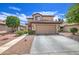 Charming two-story home with a well-manicured lawn and desert landscaping at 11301 W Glenrosa Ave, Phoenix, AZ 85037