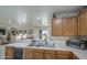A modern kitchen with a sink, wood cabinets and a breakfast bar at 11301 W Glenrosa Ave, Phoenix, AZ 85037