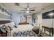 The main bedroom features a ceiling fan, tv and dresser at 11301 W Glenrosa Ave, Phoenix, AZ 85037