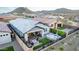 This private backyard oasis includes a covered patio, a sunken spa, and a cozy fire pit area at 13384 W Red Range Way, Peoria, AZ 85383