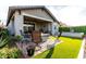 Expansive backyard with a covered patio, fire pit, lush greenery, and a serene pool at 13384 W Red Range Way, Peoria, AZ 85383