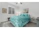 Charming bedroom featuring a comfortable bed, window with plantation shutters, and decorative accents at 13384 W Red Range Way, Peoria, AZ 85383