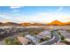 Aerial view of a new community featuring modern homes set against a scenic desert and mountain backdrop at 13384 W Red Range Way, Peoria, AZ 85383
