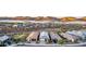Wide view of a residential community built in a desert landscape, framed by mountains at sunset at 13384 W Red Range Way, Peoria, AZ 85383