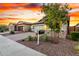 Well-maintained home with a brick driveway, two-car garage, and beautifully landscaped front yard at 13384 W Red Range Way, Peoria, AZ 85383