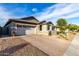Lovely home with a paved driveway, a two-car garage, and a well-kept front yard at 13384 W Red Range Way, Peoria, AZ 85383