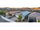 Stylish single-story home boasts a two-car garage, low maintenance landscaping, and a well-kept lawn at 13384 W Red Range Way, Peoria, AZ 85383
