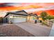 Attractive home with brick driveway, two-car garage, landscaped front yard, and stone accents at 13384 W Red Range Way, Peoria, AZ 85383