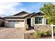 Charming single-Gathering home with a two-car garage, stone accents, and a manicured front yard at 13384 W Red Range Way, Peoria, AZ 85383
