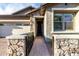 Inviting front entrance with a stone pathway leading to the front door and an attached two-car garage at 13384 W Red Range Way, Peoria, AZ 85383