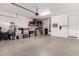 Spacious garage with epoxy flooring and ample storage, providing functionality and a clean, organized space at 13384 W Red Range Way, Peoria, AZ 85383