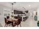 Open concept kitchen with dark wood cabinetry, granite countertops, stainless steel appliances, and an island with seating at 13384 W Red Range Way, Peoria, AZ 85383
