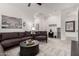 Spacious living room with comfortable seating, modern decor, carpet, and a ceiling fan at 13384 W Red Range Way, Peoria, AZ 85383