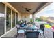 Relaxing covered patio featuring comfortable seating and a view of the pool at 13384 W Red Range Way, Peoria, AZ 85383