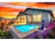 Stunning pool area with a Buddha statue, lush plants, and ambient lighting, creating a peaceful and luxurious retreat at 13384 W Red Range Way, Peoria, AZ 85383