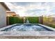 Backyard pool featuring elegant stone surround and lush greenery at 13384 W Red Range Way, Peoria, AZ 85383