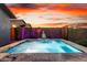 Beautiful backyard pool surrounded by lush greenery and serene lighting, perfect for relaxation at 13384 W Red Range Way, Peoria, AZ 85383