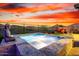 Luxurious pool with elegant stonework, zen accents, and serene landscaping, offering an idyllic outdoor escape at 13384 W Red Range Way, Peoria, AZ 85383