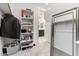 Walk-in closet leading to the bathroom, with storage shelving and carpet at 13384 W Red Range Way, Peoria, AZ 85383
