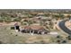 Gorgeous aerial view of home with detached garage, circular driveway, and landscaped grounds at 14118 E Rancho Del Oro Ct, Scottsdale, AZ 85262