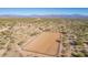 Aerial view of a rectangular equestrian arena with surrounding desert landscape and mountain views at 14118 E Rancho Del Oro Ct, Scottsdale, AZ 85262