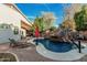 The backyard features a private pool with rock waterfall, lounge chairs, umbrella and covered patio at 1508 S Danyell Pl, Chandler, AZ 85286