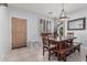 Dining room with wood table, bench seating, chandelier, and window with shutter; tiled floors at 1508 S Danyell Pl, Chandler, AZ 85286