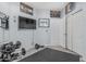 This gym features a mounted television, weights, and an open doorway at 1508 S Danyell Pl, Chandler, AZ 85286