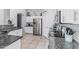 Spacious kitchen with stainless steel appliances, granite counters, white cabinetry, and a tile floor at 1508 S Danyell Pl, Chandler, AZ 85286