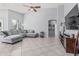 Spacious living room with high ceilings, large windows, comfortable sofa, and tiled flooring at 1508 S Danyell Pl, Chandler, AZ 85286