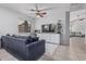 Comfortable living room with plush sofa, TV, ceiling fan, and built-in cabinets and shelving unit at 1508 S Danyell Pl, Chandler, AZ 85286