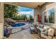 This patio features furniture and an overview of the pool and waterfall at 1508 S Danyell Pl, Chandler, AZ 85286