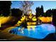 The backyard pool is the focal point, featuring a rock waterfall and integrated lighting for evening enjoyment at 1508 S Danyell Pl, Chandler, AZ 85286