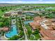 Aerial view of resort-style community featuring pools, tennis courts, lush landscaping, and beautiful Mediterranean-style buildings at 1588 E Sweet Citrus Dr, Queen Creek, AZ 85140