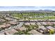 Wide aerial view showcasing the residential community, nearby golf course, and scenic mountain views in the distance at 1588 E Sweet Citrus Dr, Queen Creek, AZ 85140