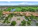 Stunning aerial view showcasing the community's manicured landscaping, clubhouse, and golf course with mountain views at 1588 E Sweet Citrus Dr, Queen Creek, AZ 85140