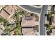 Aerial view of a home with solar panels, an outdoor patio area, and lush desert landscaping, nestled in a vibrant community at 1588 E Sweet Citrus Dr, Queen Creek, AZ 85140