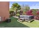 Landscaped backyard with artificial grass and a hot tub at 1588 E Sweet Citrus Dr, Queen Creek, AZ 85140