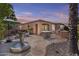 Beautiful backyard with a fountain, patio furniture, and well-maintained landscaping at 1588 E Sweet Citrus Dr, Queen Creek, AZ 85140