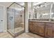Bathroom featuring dark wood cabinets, earth-toned tile flooring and glass-enclosed shower at 1588 E Sweet Citrus Dr, Queen Creek, AZ 85140