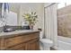 Elegant bathroom with granite countertop, decorative tile, and a bathtub with shower at 1588 E Sweet Citrus Dr, Queen Creek, AZ 85140